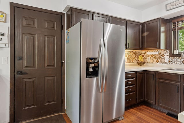 6242 Pecan St, North Branch, MN 55056 - kitchen featuring stainless steel refrigerator with ice dispenser, a sink, light countertops, dark brown cabinetry, and wood finished floors