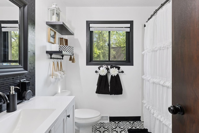 6242 Pecan St, North Branch, MN 55056 - bathroom featuring backsplash, toilet, vanity, and tile patterned floors