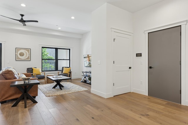 living room featuring light wood-type flooring, recessed lighting, a ceiling fan, and baseboards