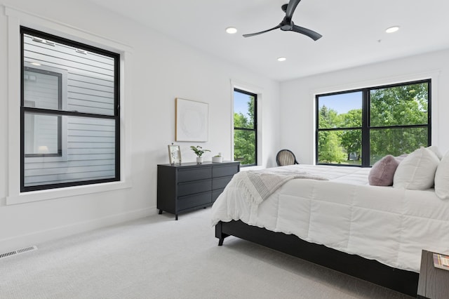 carpeted bedroom featuring baseboards, recessed lighting, and ceiling fan