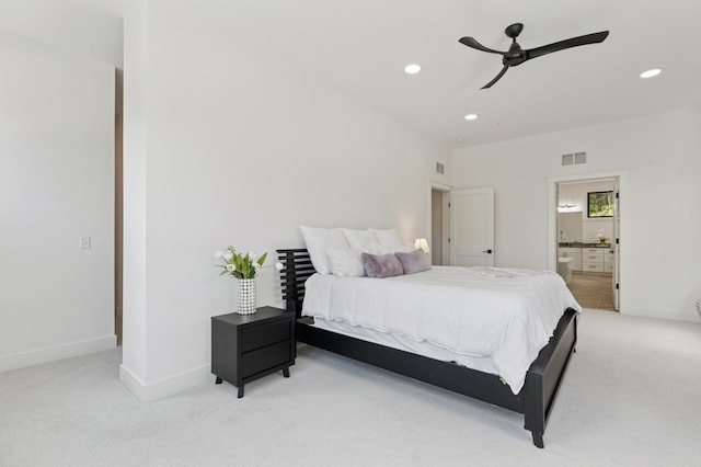 bedroom featuring light carpet, recessed lighting, baseboards, ensuite bathroom, and ceiling fan