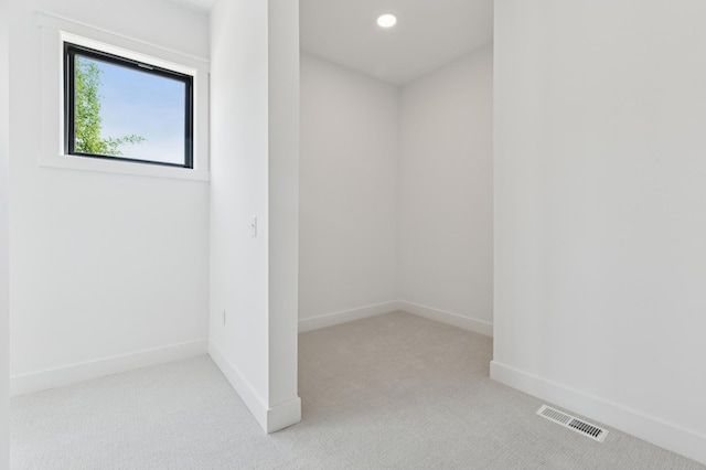 spare room featuring carpet floors, baseboards, and recessed lighting