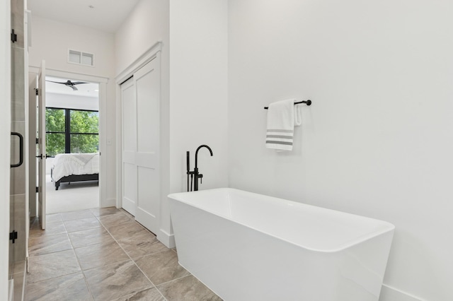 full bathroom with ensuite bath, a soaking tub, and ceiling fan