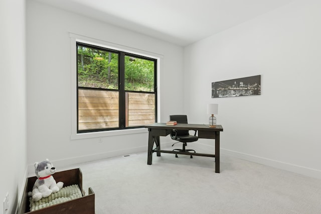carpeted office featuring baseboards
