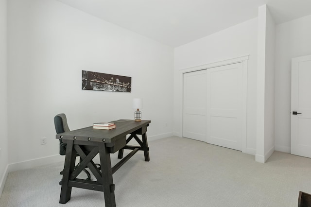 home office with light carpet and baseboards