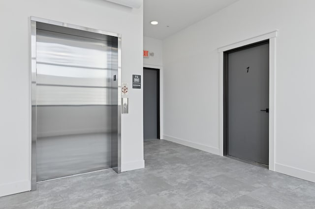 unfurnished bedroom featuring elevator, finished concrete floors, baseboards, and recessed lighting
