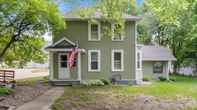 212 4, Montevideo, MN 56265 - view of front facade featuring a front yard and roof with shingles