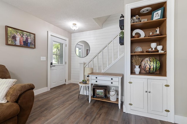 212 4, Montevideo, MN 56265 - foyer entrance featuring stairs, dark wood-type flooring, baseboards, and a textured ceiling
