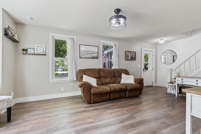 212 4, Montevideo, MN 56265 - living room with wood finished floors, a textured ceiling, stairs, and baseboards