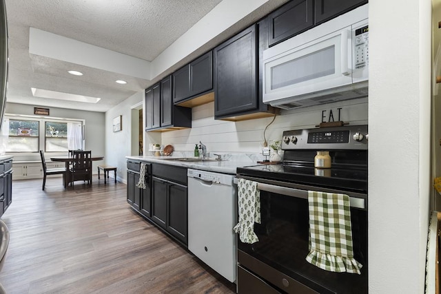 212 4, Montevideo, MN 56265 - kitchen with white appliances, a sink, a textured ceiling, dark wood finished floors, and light countertops