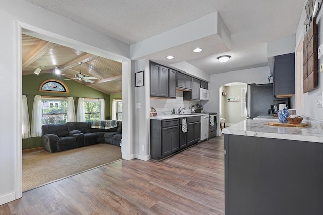 212 4, Montevideo, MN 56265 - kitchen with arched walkways, a sink, light countertops, ceiling fan, and recessed lighting
