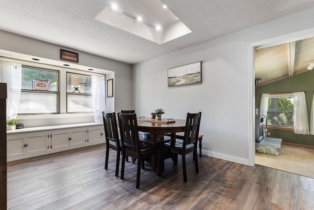 212 4, Montevideo, MN 56265 - dining room with wood finished floors, a textured ceiling, vaulted ceiling, and baseboards