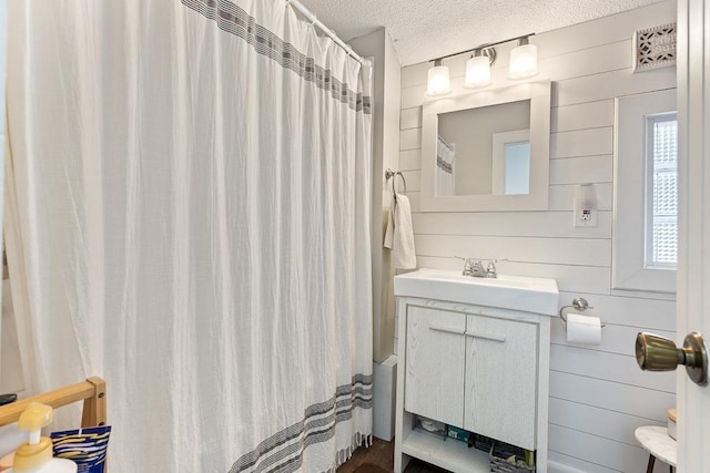 212 4, Montevideo, MN 56265 - bathroom with vanity, a textured ceiling, and a shower with shower curtain