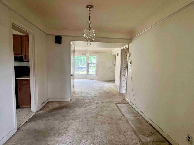 corridor featuring light colored carpet and baseboards