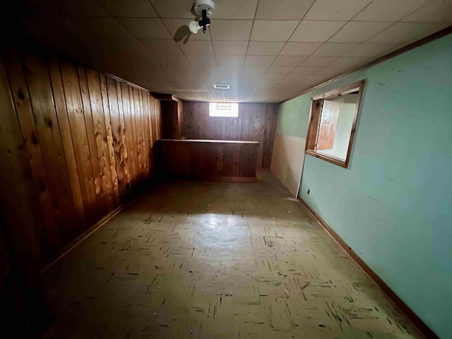 basement with wood walls and baseboards