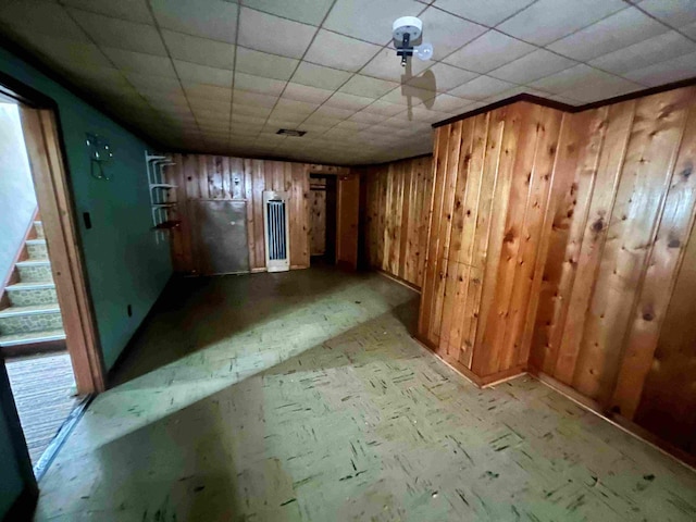unfurnished room with wooden walls and stairway
