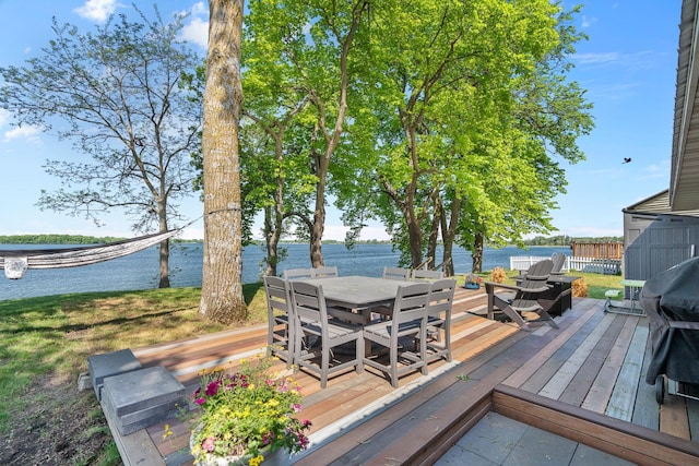 46710 Glens Beach Rd, Elysian Twp, MN 56096 - wooden deck with outdoor dining space and a water view