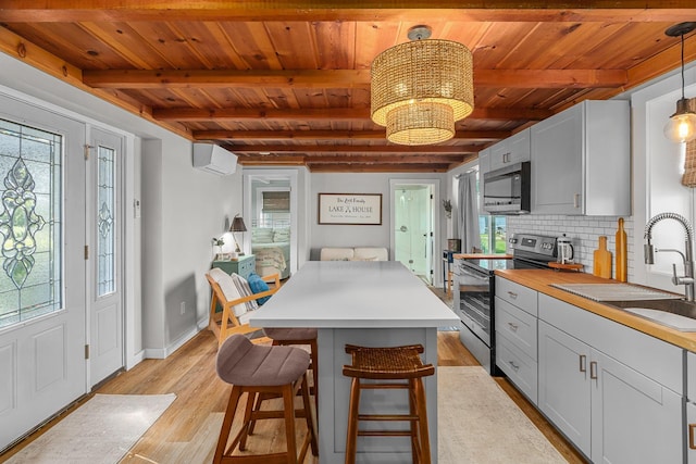 46710 Glens Beach Rd, Elysian Twp, MN 56096 - kitchen with appliances with stainless steel finishes, wooden ceiling with exposed beams, tasteful backsplash, light wood-style flooring, and a sink