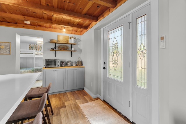 46710 Glens Beach Rd, Elysian Twp, MN 56096 - entryway featuring wood ceiling with exposed beams, light wood-style floors, and baseboards