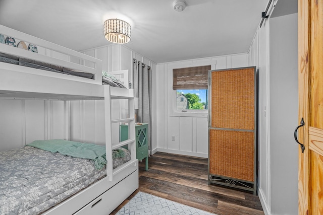 46710 Glens Beach Rd, Elysian Twp, MN 56096 - bedroom featuring a decorative wall and wood finished floors