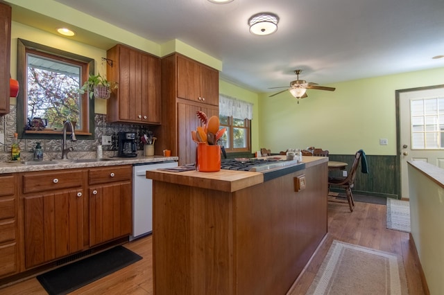 207 2nd Ave W, Balsam Lake, WI 54810 - kitchen featuring a sink, brown cabinets, plenty of natural light, and a wainscoted wall