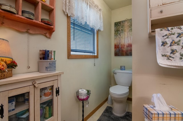 207 2nd Ave W, Balsam Lake, WI 54810 - bathroom featuring baseboards, toilet, and tile patterned floors