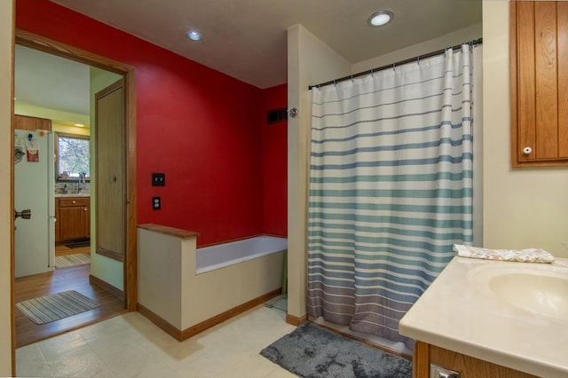 207 2nd Ave W, Balsam Lake, WI 54810 - bathroom with vanity, a bathtub, a shower with curtain, recessed lighting, and baseboards