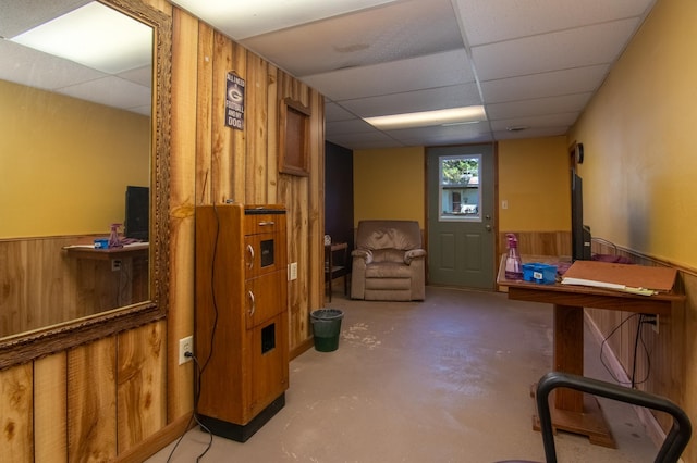 207 2nd Ave W, Balsam Lake, WI 54810 - below grade area featuring a drop ceiling, wooden walls, and wainscoting