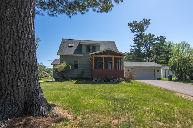 207 2nd Ave W, Balsam Lake, WI 54810 - view of front of house featuring asphalt driveway, a garage, a front lawn, a sunroom, and roof with shingles