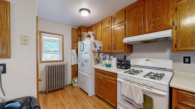 kitchen featuring radiator, white appliances, under cabinet range hood, brown cabinets, and light countertops