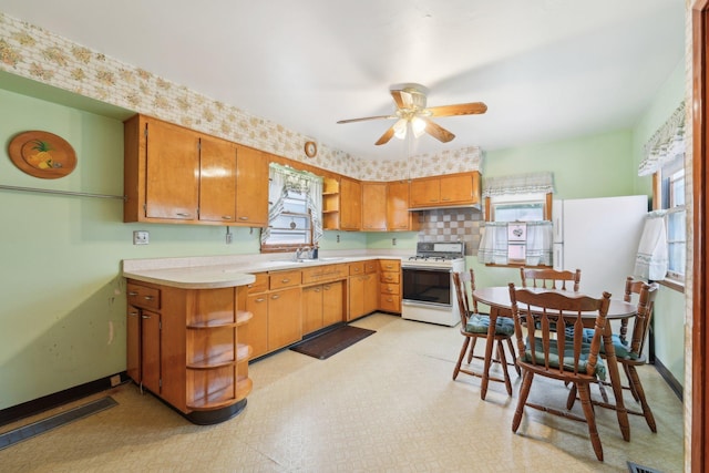 4518 Colfax Ave N, Minneapolis, MN 55412 - kitchen with gas range gas stove, a sink, light countertops, a ceiling fan, and open shelves
