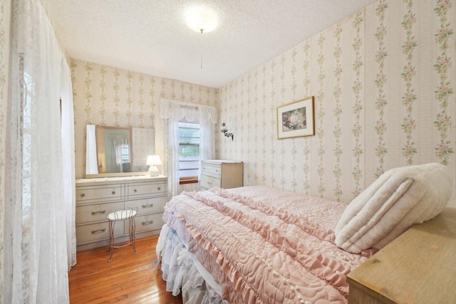 4518 Colfax Ave N, Minneapolis, MN 55412 - bedroom featuring hardwood / wood-style floors, wallpapered walls, and a textured ceiling