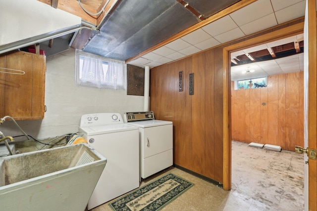 4518 Colfax Ave N, Minneapolis, MN 55412 - laundry room featuring wood walls, separate washer and dryer, cabinet space, and light flooring