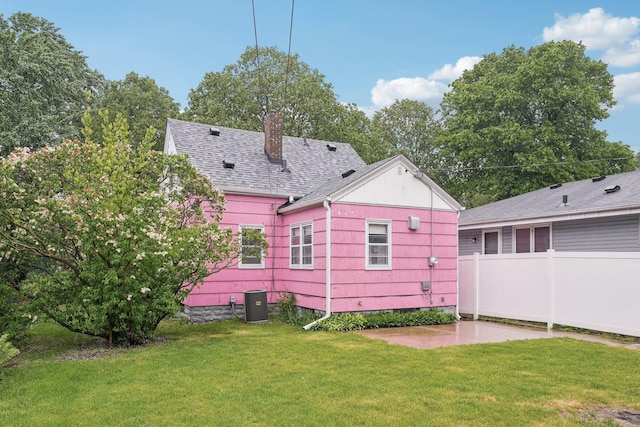 4518 Colfax Ave N, Minneapolis, MN 55412 - rear view of house featuring a chimney, a patio area, roof with shingles, and central air condition unit