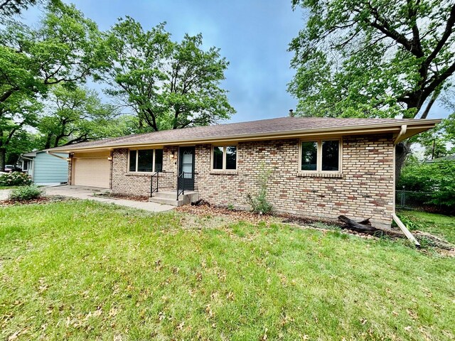 25 103rd Ave NW, Coon Rapids, MN 55448 - ranch-style home featuring a garage, a front lawn, and brick siding