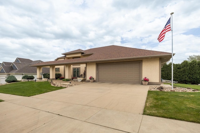 2592 Aspen Pl SW, Rochester, MN 55902 - view of front of house featuring a garage, concrete driveway, a front yard, and stucco siding