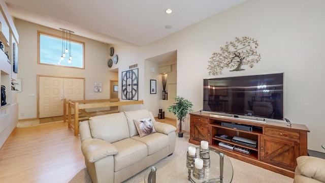 2592 Aspen Pl SW, Rochester, MN 55902 - living room featuring baseboards, a high ceiling, recessed lighting, and light wood-style floors