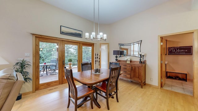 2592 Aspen Pl SW, Rochester, MN 55902 - dining area featuring light wood finished floors, a chandelier, and baseboards