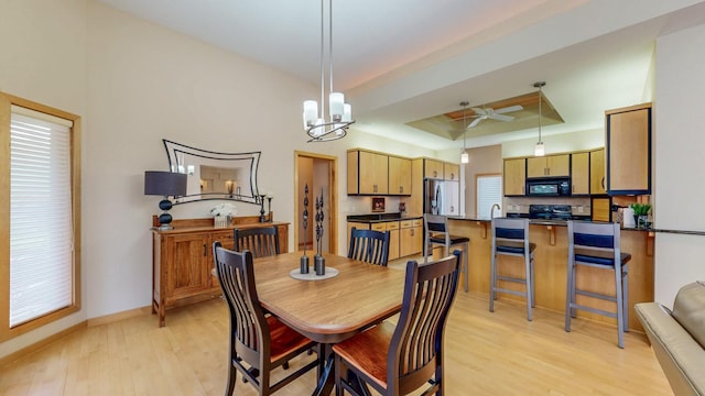 2592 Aspen Pl SW, Rochester, MN 55902 - dining room with light wood-style floors, a raised ceiling, ceiling fan, baseboards, and a chandelier