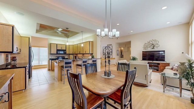 2592 Aspen Pl SW, Rochester, MN 55902 - dining space with light wood-style flooring, ceiling fan, a raised ceiling, recessed lighting, and a chandelier