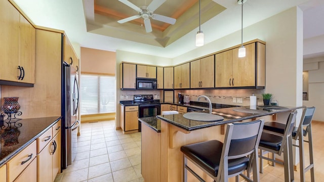 2592 Aspen Pl SW, Rochester, MN 55902 - kitchen with black microwave, a tray ceiling, stainless steel fridge, stove, and a peninsula