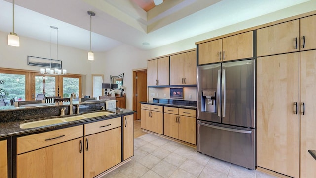 2592 Aspen Pl SW, Rochester, MN 55902 - kitchen with stainless steel fridge with ice dispenser, a sink, light tile patterned flooring, dark stone counters, and decorative light fixtures