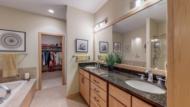 2592 Aspen Pl SW, Rochester, MN 55902 - bathroom with a shower stall, a bath, double vanity, tile patterned flooring, and a walk in closet