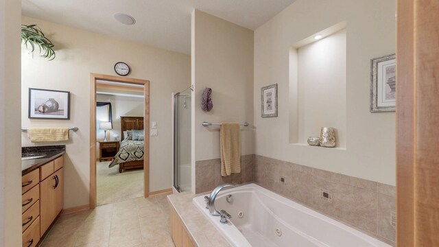 2592 Aspen Pl SW, Rochester, MN 55902 - full bathroom with ensuite bath, a whirlpool tub, vanity, tile patterned floors, and a shower stall