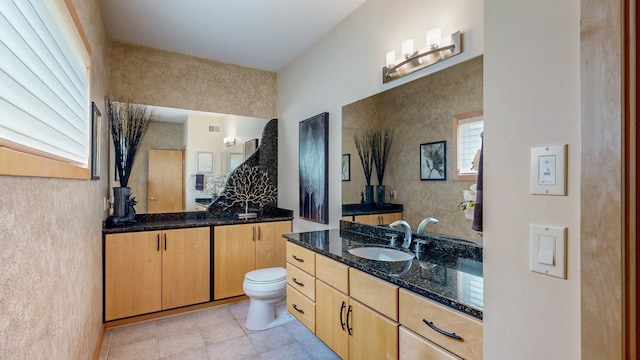 2592 Aspen Pl SW, Rochester, MN 55902 - bathroom featuring two vanities, toilet, and tile patterned floors