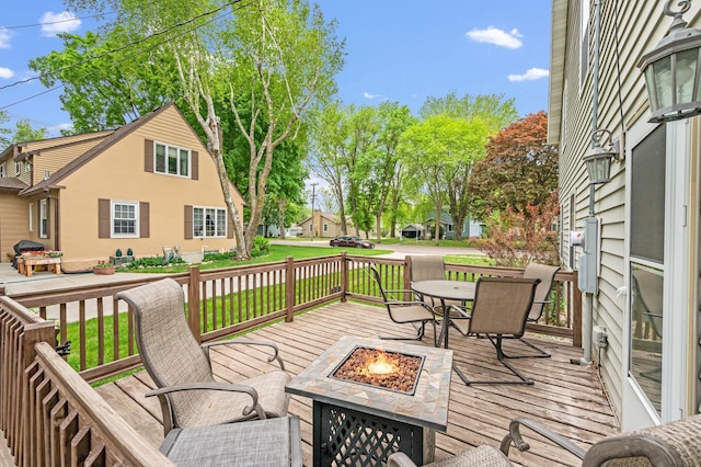 114 3rd Ave E, Truman, MN 56088 - deck featuring a fire pit, a yard, and area for grilling