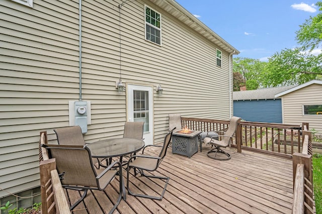 114 3rd Ave E, Truman, MN 56088 - wooden terrace featuring outdoor dining area and an outdoor fire pit