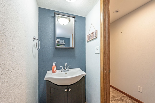 114 3rd Ave E, Truman, MN 56088 - bathroom with vanity, tile patterned floors, and a textured wall