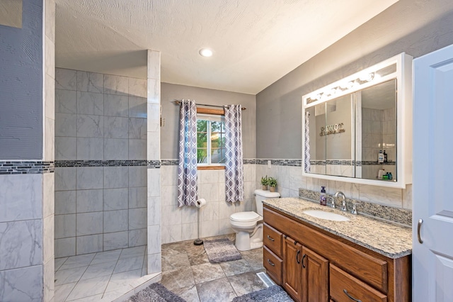 114 3rd Ave E, Truman, MN 56088 - bathroom with tile walls, toilet, walk in shower, vanity, and recessed lighting