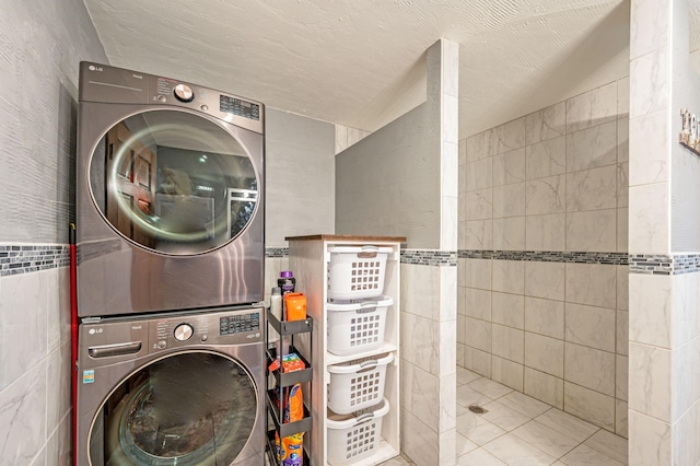 114 3rd Ave E, Truman, MN 56088 - laundry area with estacked washer and dryer and tile walls